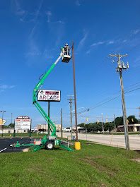 Boom lift positioned for commercial signage electrical work