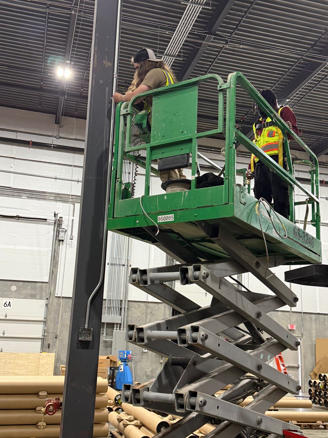 Savant Solutions electrician working from a scissor lift on a commercial installation