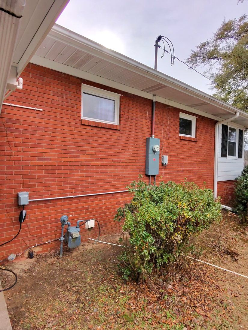 Completed exterior electrical service upgrade on a brick home
